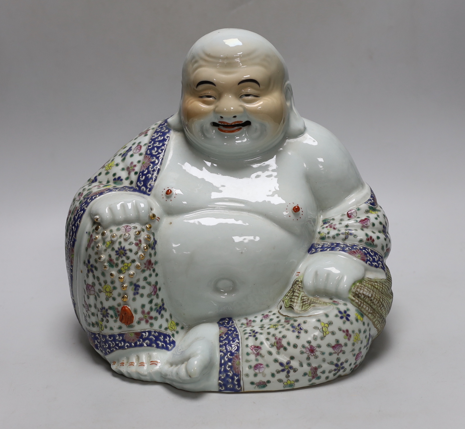 A Chinese famille rose seated figure of Budai, Republic period, 26cm high